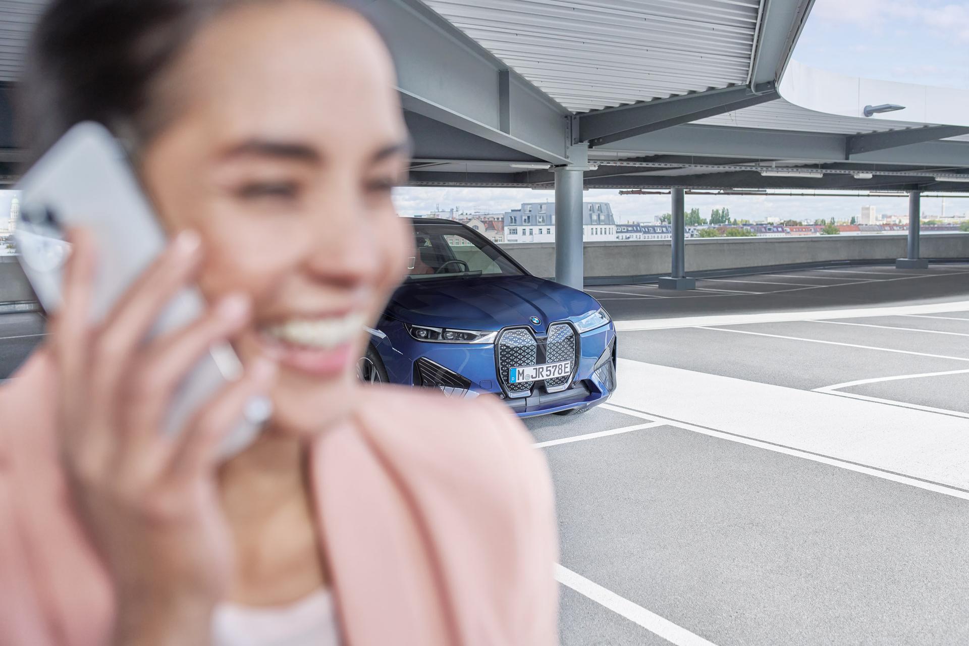 business woman smartphone parking deck blurry
