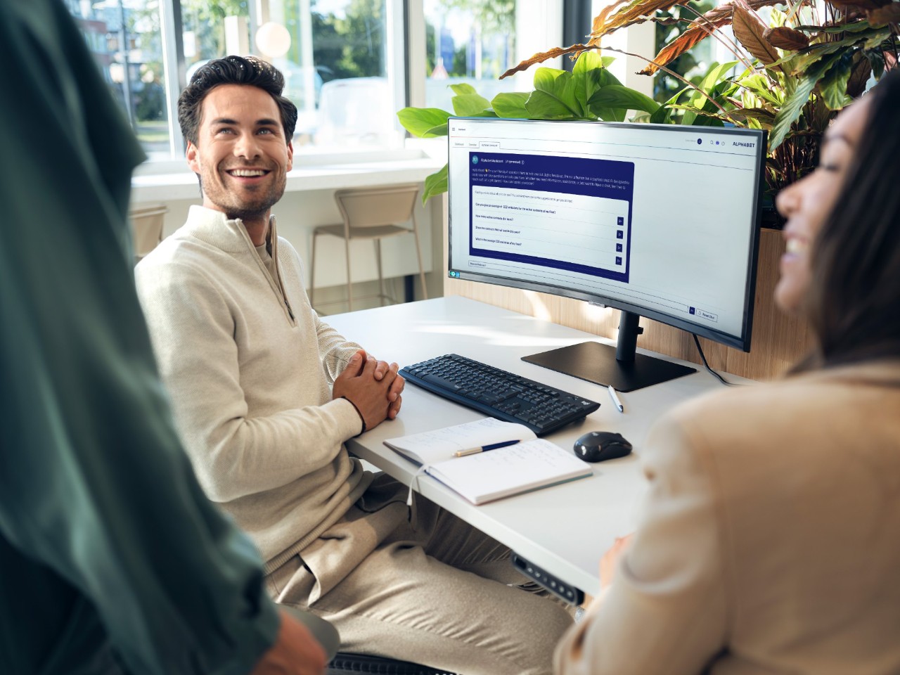 Man in office in front of open dashboard on monitor.