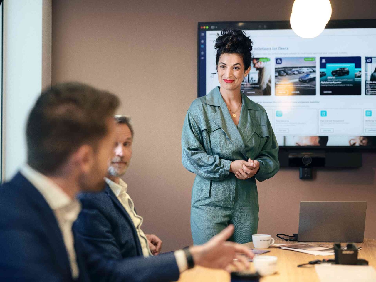 Person giving a presentation to colleagues during a business meeting.
