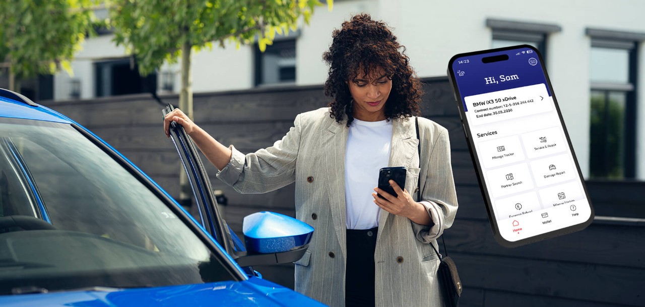 Person using the Alphabet app next to a blue car to manage vehicle information and services.