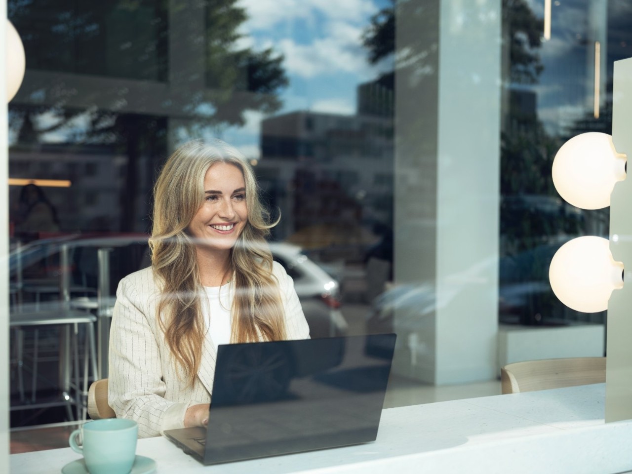 Lady smiling at a laptop