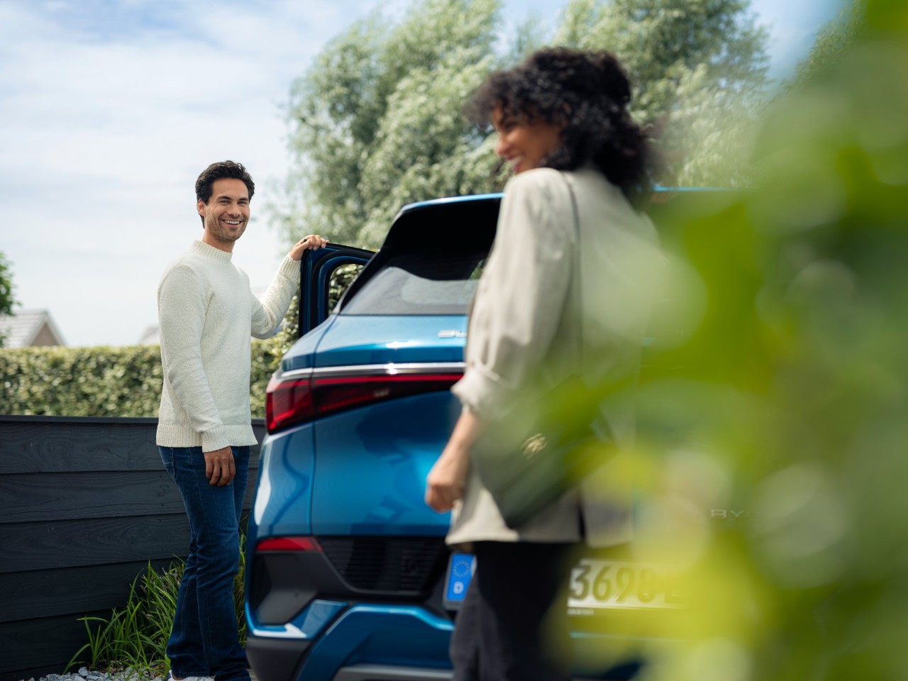 Man and Woman standing near a car