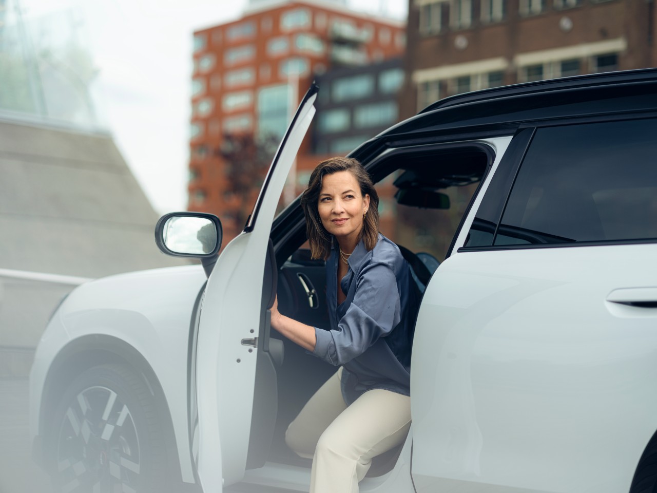 Woman opening door as she gets out of Car