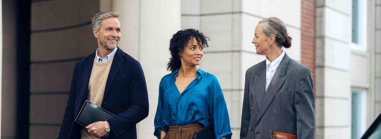 Dos señores con chica de blusa azul andando