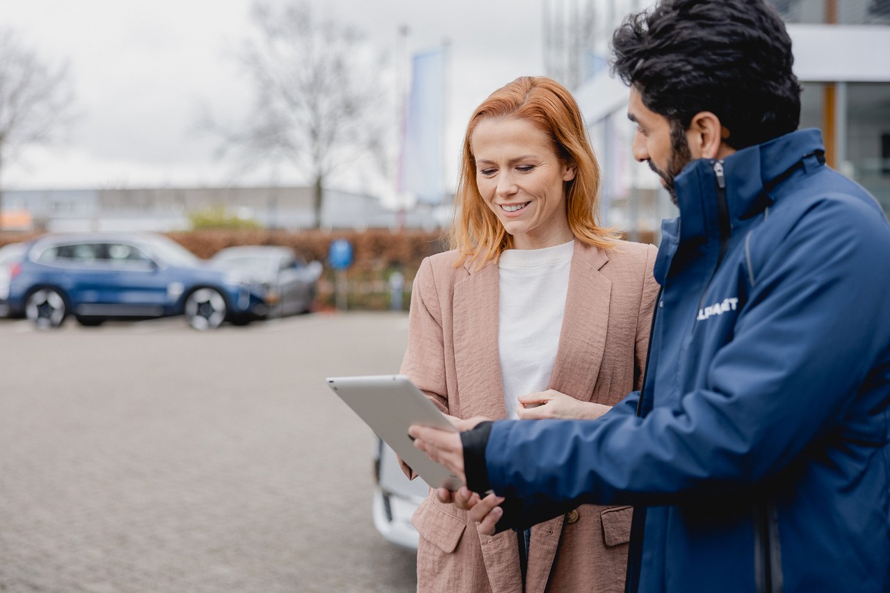 Mujer hablando con un experto, mirando una tablet con detalles